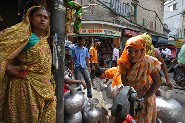 women at a waterpost